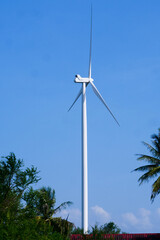 Wind Turbine Power: A towering wind turbine generating clean energy against a backdrop of a clear...