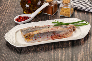 Salted marinated herring fillet with spices