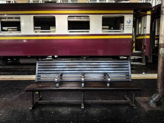 Empty Wooden Bench on a Train Station Platform