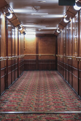Corridor or aisle to cabins, staterooms or suites on historic old Art Deco interiors design luxury...