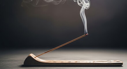 Incense stick burning with smoke in a holder still life