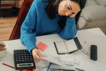 Stressed accountant woman managing finance and calculating tax using calculator