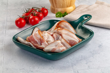 Raw pork tenferloin with bacon