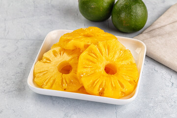 Sweet canned pineapple slices in syrope