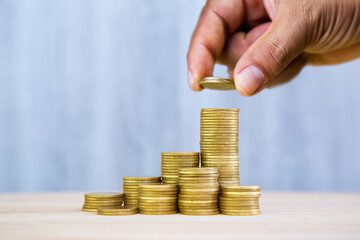 Hand stacking coins, symbolizing growth, saving, or investment. Financial planning. financial success, step-by-step wealth building, and the importance of consistent saving. Ideal for personal,