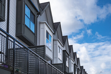 Real Estate Exterior Front townhomes. Facade of a row of modern urban townhouses