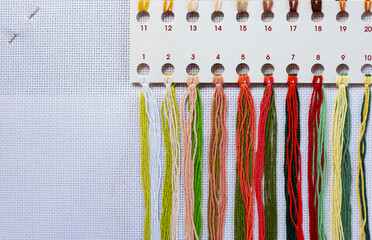 Close-up of several bundles of multi-colored embroidery floss. Bright, colorful set of embroidery...