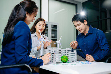 Business Team Meeting with Wind Turbine, Earth Model, and Building Prototype for Clean Energy