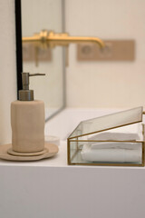 Elegant Bathroom Decor with Soap Dispenser and Glass Box