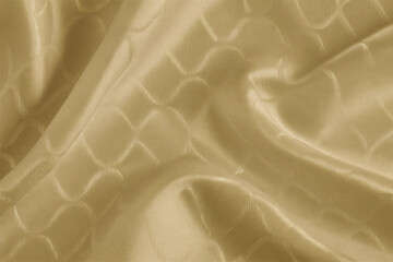 Smooth, elegant golden silk fabric with a flowing, shiny texture creates a luxurious backdrop