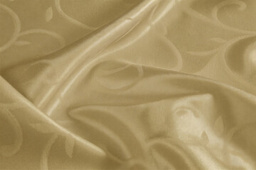 Smooth, elegant golden silk fabric with a flowing, shiny texture creates a luxurious backdrop