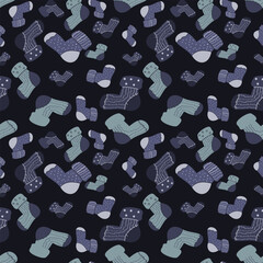 Seamless pattern of cozy socks in cool blue tones on dark blue, ideal for children's winter clothes, snug pajamas, and baby textile prints.