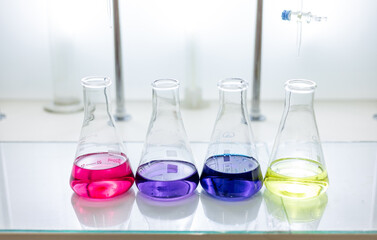 Chemistry laboratory glassware with colour liquids. Chemicals in glass flasks. Chemicals in glass...