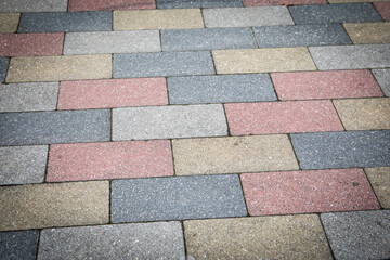 Colorful Paving Stone Pattern on Urban Sidewalk with Concrete Texture and Geometric Arrangement