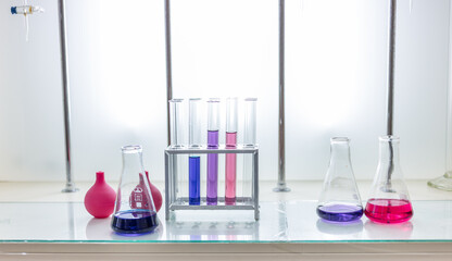 Laboratory analysis. Flask and test tubes on white table indoors, closeup. Laboratory test-tubes...