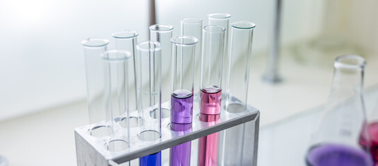 Laboratory analysis. Flask and test tubes on white table indoors, closeup. Laboratory test-tubes...