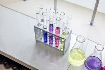 Laboratory analysis. Flask and test tubes on white table indoors, closeup. Laboratory test-tubes...