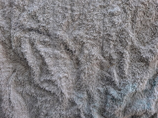 Textured Gray Fabric: Close-up view of a crumpled gray fabric with a fuzzy texture, showing depth and folds.