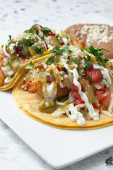 A closeup view of a plate of fish tacos.