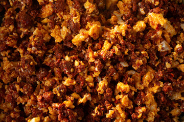 A top down view of a pile chorizo con huevos, as a background.