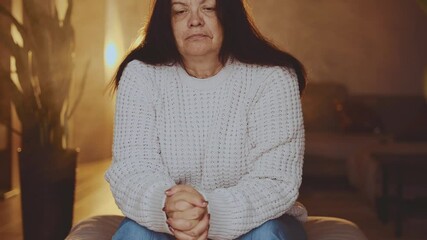sad senior woman is nervous under stress fidget and pray, depression emotion. lonely old age lady feels bad mental health. coping with grief misfortune panic attack. room with sun ray light with hope