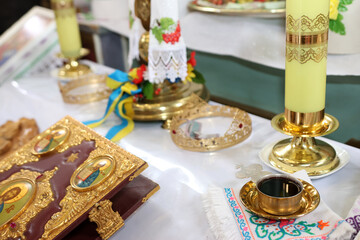 The Gospel, a chalice of wine, and other church objects on the altar.