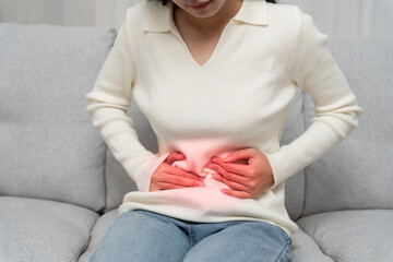stomach ache. Asian women have abdominal pain, indigestion, gastritis, menstrual cramps,...
