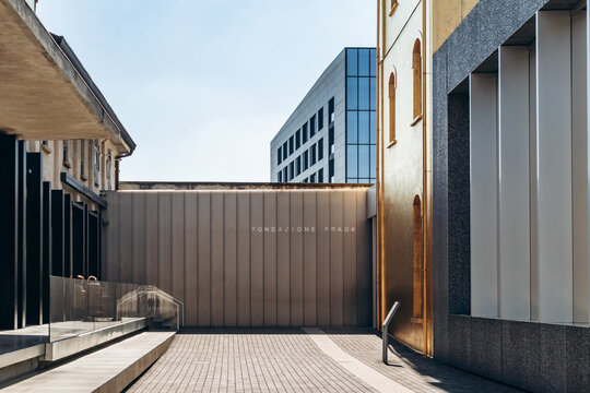 Milan, Italy - March 19, 2025 : Entrance to Fondazione Prada with modern facade and golden wall
