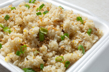 A view of a container of Filipino style garlic rice.