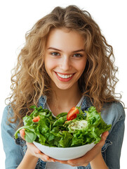 Smiling young woman with curly hair holding a fresh salad bowl filled with greens and tomatoes, showcasing a healthy lifestyle in a bright setting. on transparent background