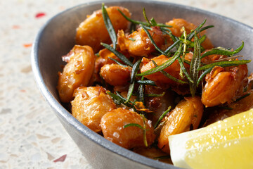 A closeup view of a bowl of fried gigante beans.