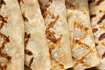 A top down view of burritos with grill marks, as a background.