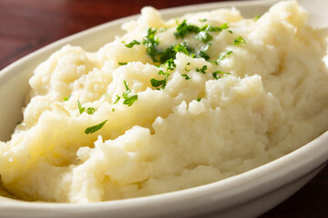 A closeup view of a bowl of mashed potatoes.