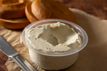 A closeup view of a plastic container of diary-free cream cheese spread.