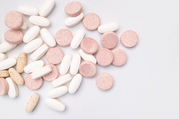 Different tablets, vitamins, pills, dietary supplements on light gray background close-up. Concept...