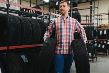 Man chooses winter car tires in the auto shop