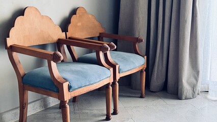 Two vintage white wooden chairs with blue and purple velvet upholstery Isolated on white...