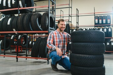 Man chooses winter car tires in the auto shop