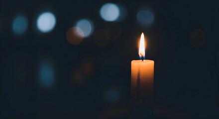 Burning candle in the dark background