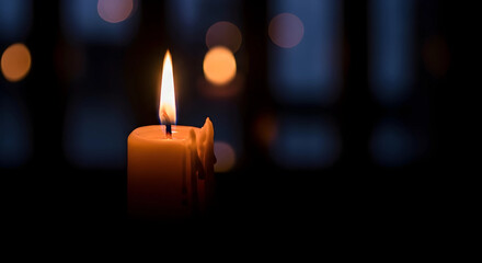 Burning candle in the dark background