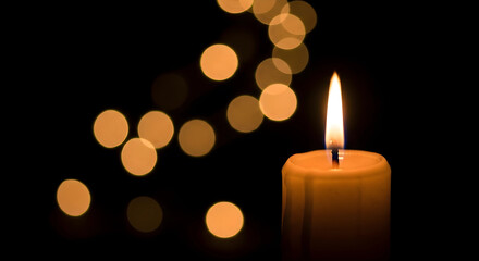 Burning candle in the dark background
