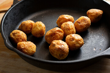 A view of a cast iron skillet of polenta roasted potatoes.