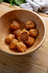 A view of polenta roasted potatoes in a bamboo bowl.