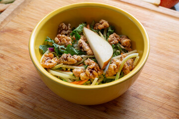 A view of a bowl of candied walnut salad.