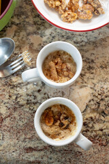 A top down view of microwave cookies in small mugs.