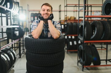 Funny tire shop employee having fun at work