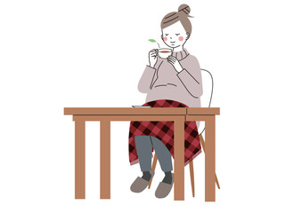 温かいお茶とひざ掛けで体を温めている妊婦さん
