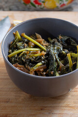 A view of a bowl of a kohlrabi greens entree.