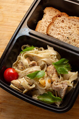 A top down view of a container of chicken scampi.