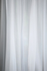 Obraz premium Delicate White Curtain: A flowing white curtain gently filters light, creating a soft and airy ambiance in a scene evoking serenity and calmness.